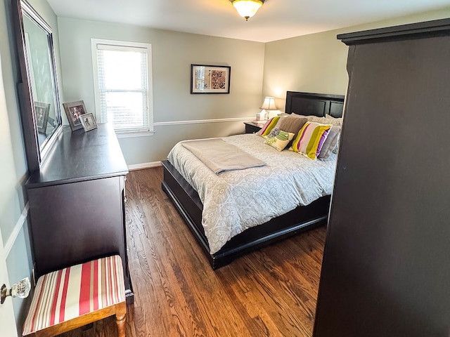 bedroom featuring wood finished floors and baseboards