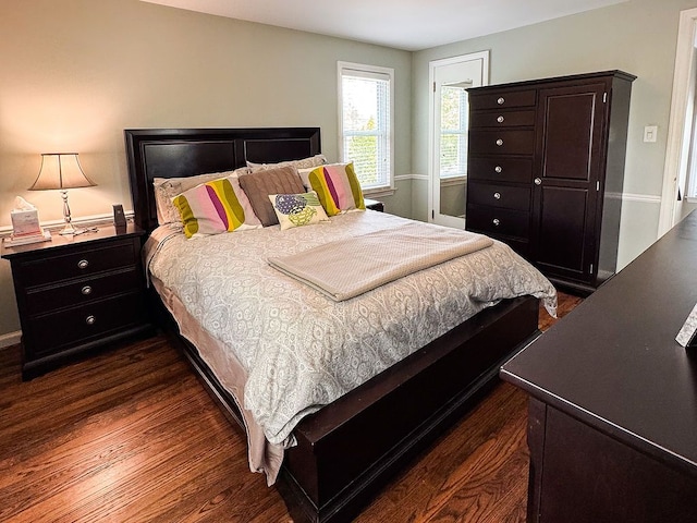 bedroom featuring dark wood-style flooring