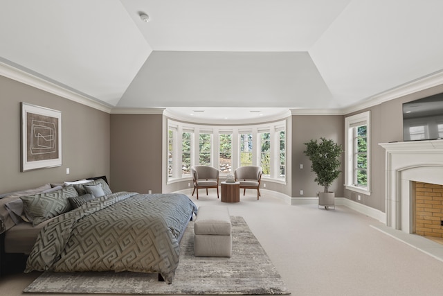 bedroom featuring lofted ceiling, carpet flooring, ornamental molding, a fireplace with raised hearth, and baseboards
