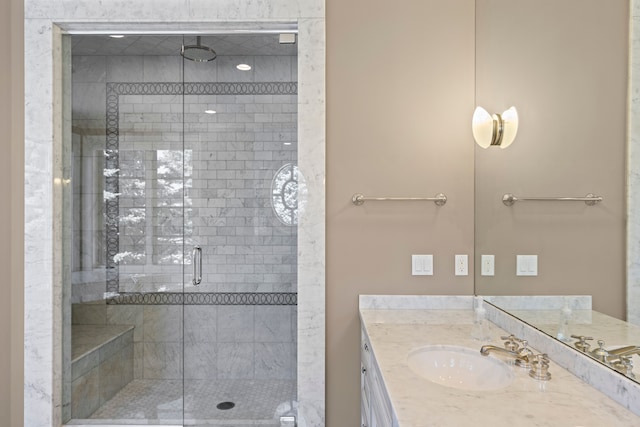 bathroom with a stall shower and vanity