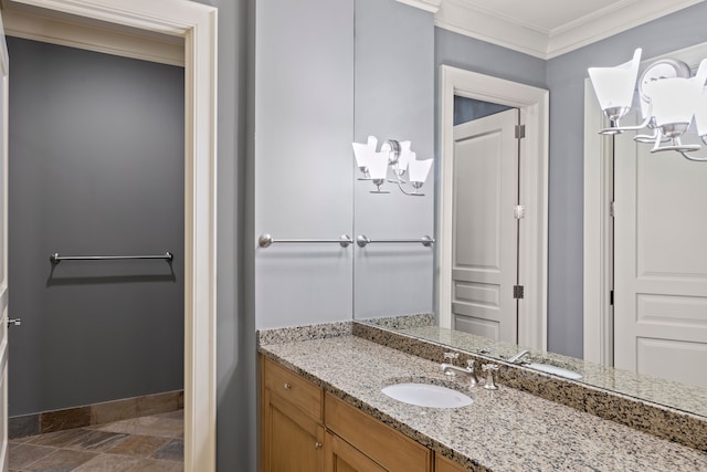 bathroom with a chandelier, ornamental molding, vanity, baseboards, and stone finish flooring