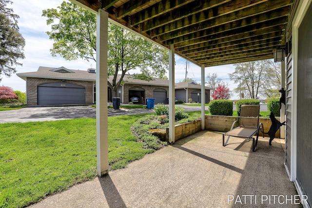 618 Edgewater Dr, Spring Lake, MI 49456 - view of patio featuring a garage and driveway