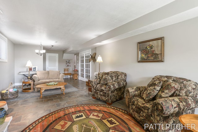 618 Edgewater Dr, Spring Lake, MI 49456 - living area with french doors, stone finish flooring, baseboards, and a chandelier