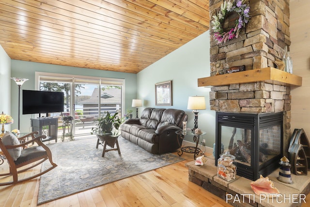 618 Edgewater Dr, Spring Lake, MI 49456 - living area featuring lofted ceiling, wood-type flooring, a stone fireplace, and wood ceiling