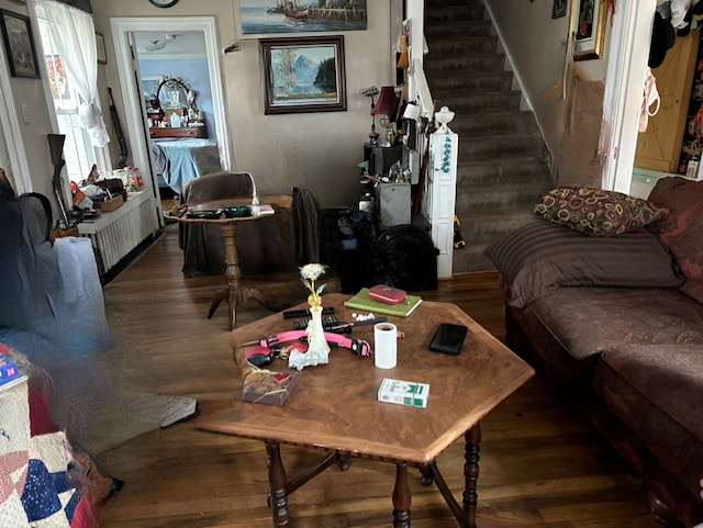 4201 Chicago Rd, Warren, MI 48092 - living area with wood finished floors, radiator heating unit, and stairs