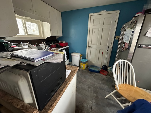 4201 Chicago Rd, Warren, MI 48092 - kitchen with white electric range oven, white cabinets, and concrete floors