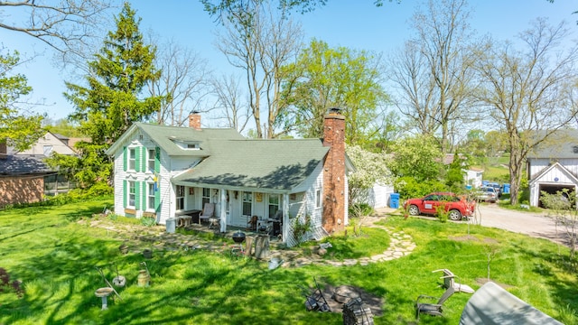 4201 Chicago Rd, Warren, MI 48092 - back of property featuring covered porch, a chimney, a yard, and driveway