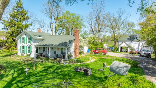 4201 Chicago Rd, Warren, MI 48092 - back of property with covered porch, a chimney, a lawn, driveway, and roof with shingles