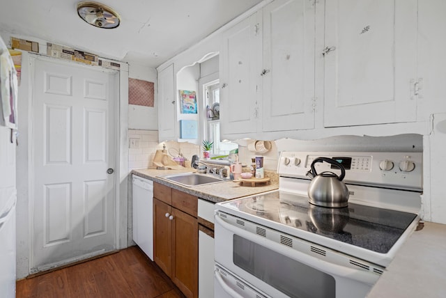4201 Chicago Rd, Warren, MI 48092 - kitchen featuring white appliances, light countertops, dark wood-type flooring, brown cabinetry, and a sink
