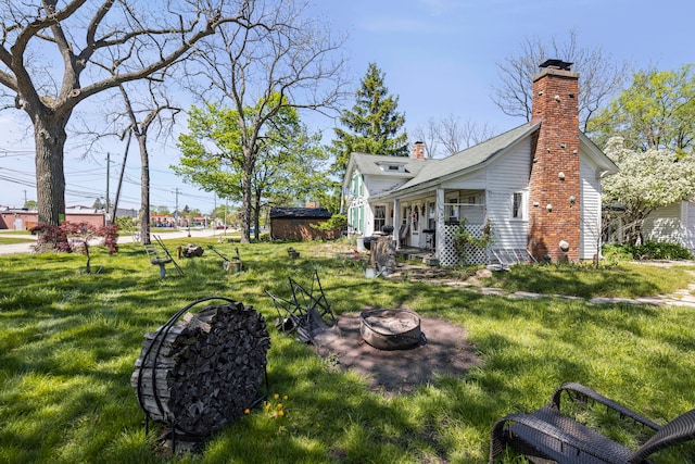 4201 Chicago Rd, Warren, MI 48092 - view of green lawn with an outdoor fire pit
