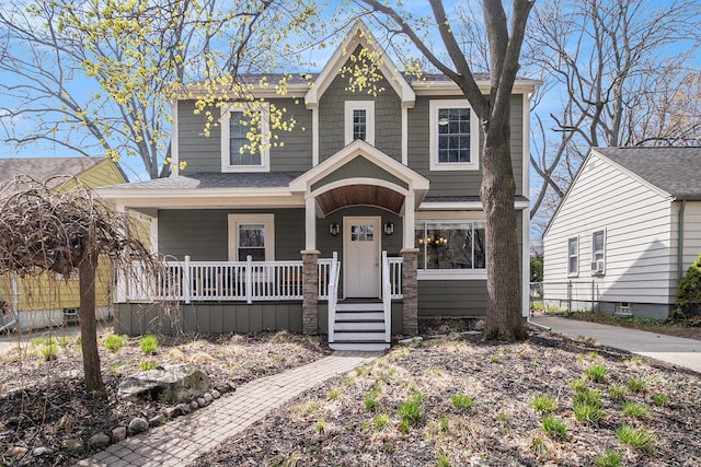 view of front of home featuring covered porch, cooling unit, and a shingled roof