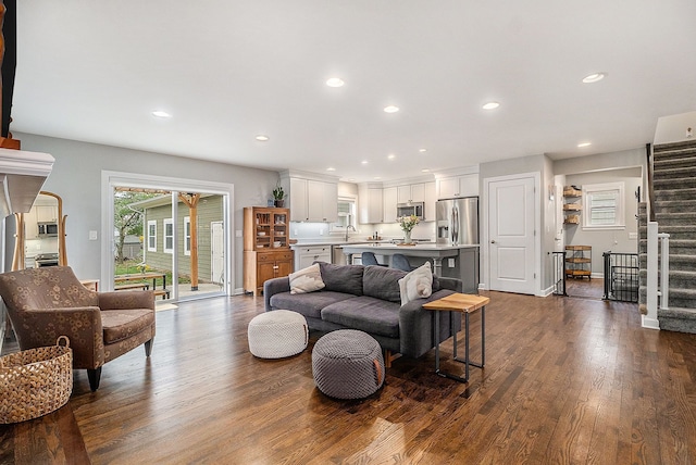 living area with stairs, dark wood-style floors, and recessed lighting