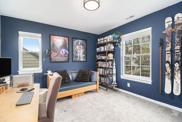 carpeted home office with baseboards