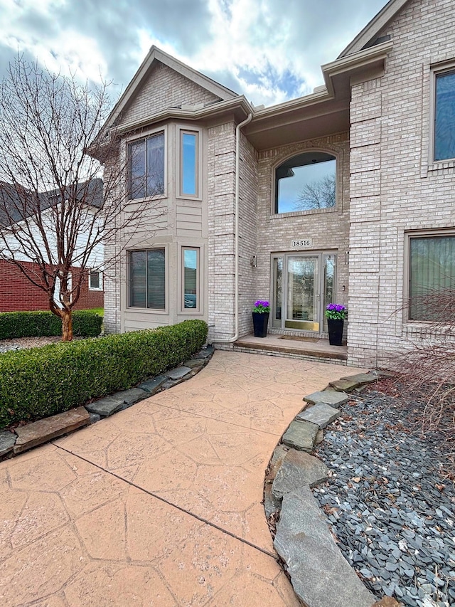 18516 Ranier Dr, Macomb, MI 48042 - rear view of property with brick siding