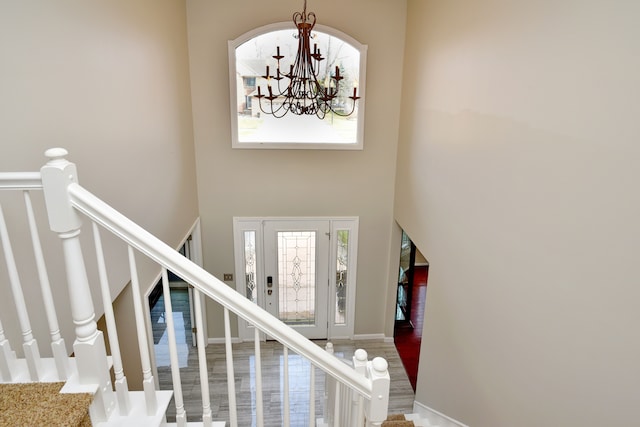 18516 Ranier Dr, Macomb, MI 48042 - entrance foyer with plenty of natural light, a chandelier, a towering ceiling, stairs, and wood finished floors