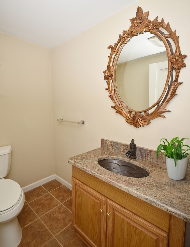 18516 Ranier Dr, Macomb, MI 48042 - bathroom with toilet, vanity, tile patterned flooring, and baseboards