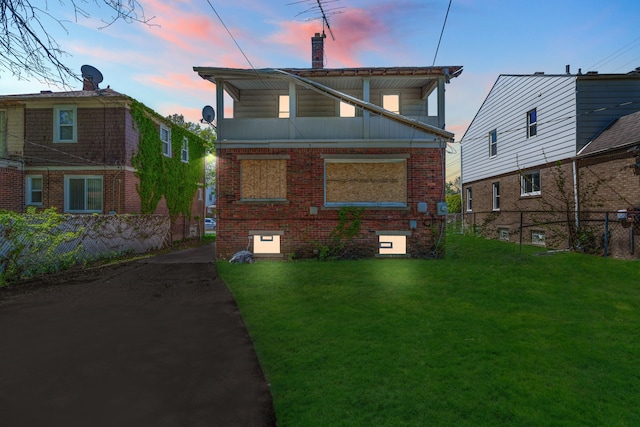 back of property with a chimney and brick siding