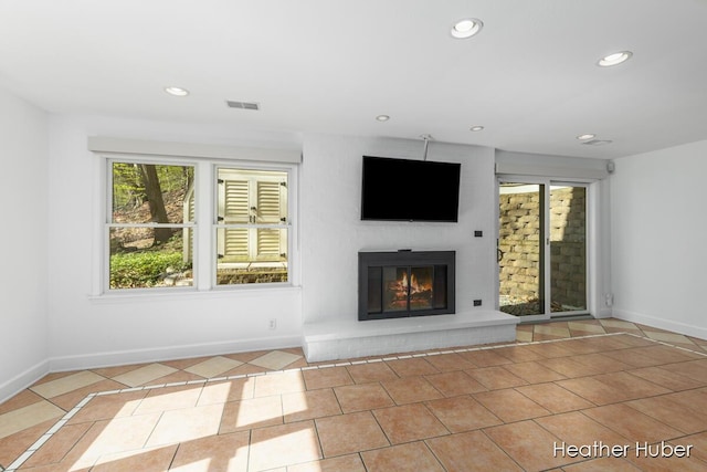 401 Stickney Ridge Rd, Grand Haven, MI 49417 - unfurnished living room featuring tile patterned floors, a glass covered fireplace, and recessed lighting