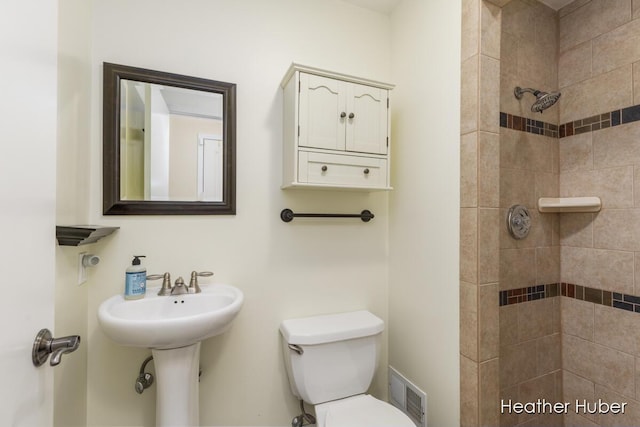 401 Stickney Ridge Rd, Grand Haven, MI 49417 - bathroom featuring a tile shower and toilet