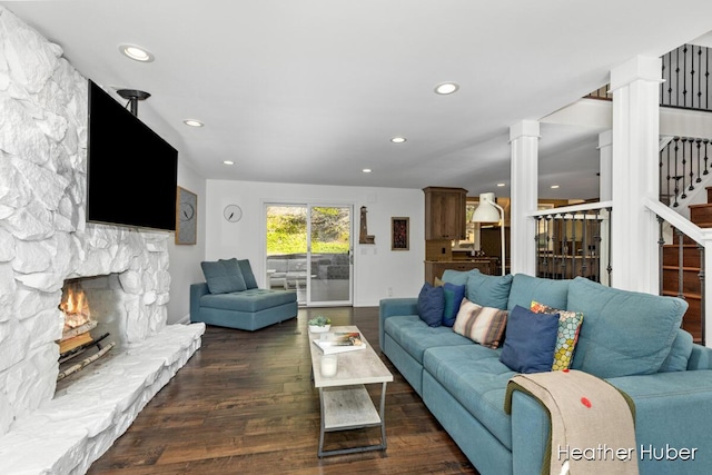 401 Stickney Ridge Rd, Grand Haven, MI 49417 - living area featuring a stone fireplace, decorative columns, dark wood-style flooring, recessed lighting, and stairs