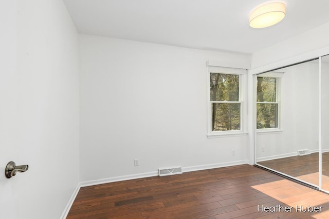 401 Stickney Ridge Rd, Grand Haven, MI 49417 - unfurnished bedroom featuring hardwood / wood-style flooring and a closet