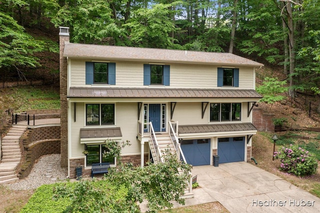 401 Stickney Ridge Rd, Grand Haven, MI 49417 - view of front of house featuring stairs, a garage, a chimney, and driveway