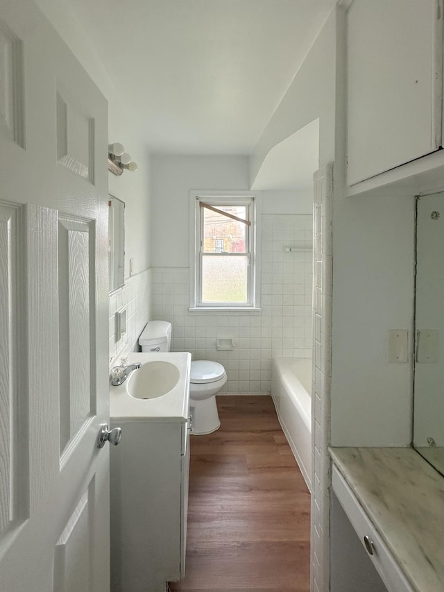 17124 Pinehurst St, Detroit, MI 48221 - bathroom with tile walls, toilet, vanity, wood finished floors, and wainscoting