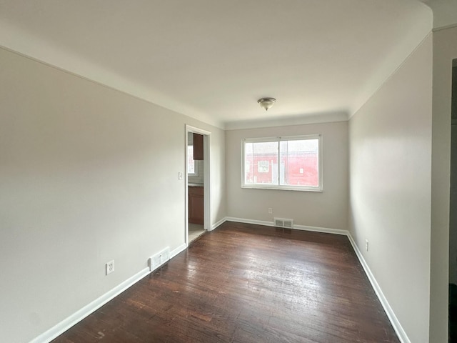 17124 Pinehurst St, Detroit, MI 48221 - spare room featuring dark wood-type flooring and baseboards