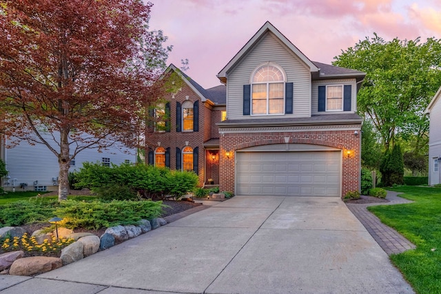 1090 Shetland Dr, South Lyon, MI 48178 - view of front of house featuring driveway, an attached garage, and brick siding