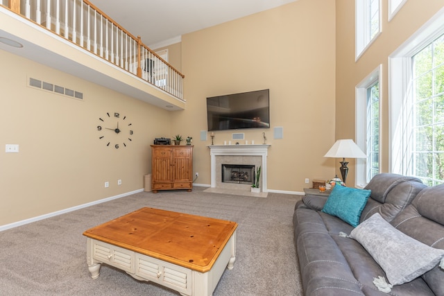 1090 Shetland Dr, South Lyon, MI 48178 - carpeted living area with a high ceiling, a fireplace, and baseboards