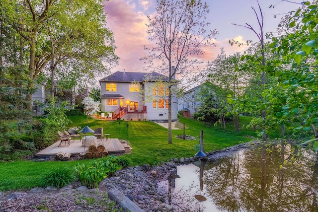 1090 Shetland Dr, South Lyon, MI 48178 - rear view of house with a lawn and a wooden deck