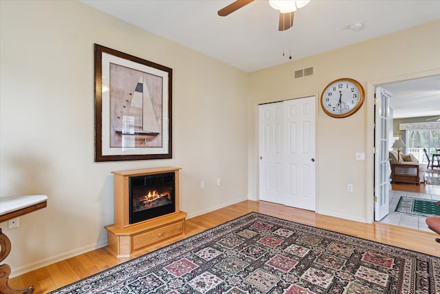 3818 Hillsdale Dr, Auburn Hills, MI 48326 - bedroom with wood finished floors, a glass covered fireplace, baseboards, and ceiling fan
