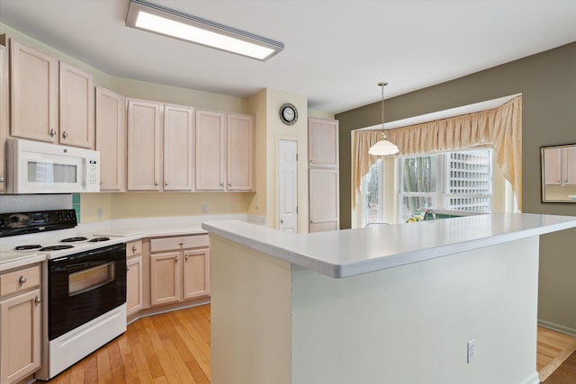 3818 Hillsdale Dr, Auburn Hills, MI 48326 - kitchen with white microwave, electric range oven, light wood-style floors, and light countertops
