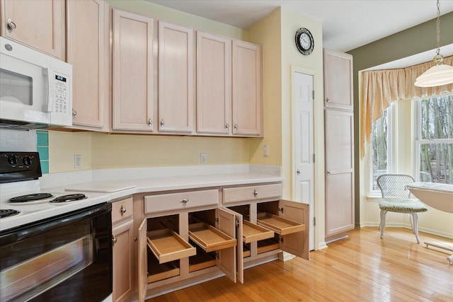 3818 Hillsdale Dr, Auburn Hills, MI 48326 - kitchen featuring electric range oven, white microwave, light countertops, and light wood-style flooring