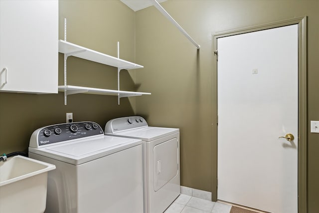 3818 Hillsdale Dr, Auburn Hills, MI 48326 - laundry area with washer and dryer, cabinet space, and light tile patterned flooring
