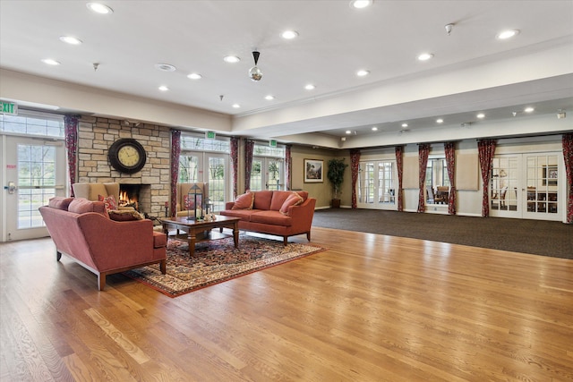 3818 Hillsdale Dr, Auburn Hills, MI 48326 - living area with crown molding, french doors, wood finished floors, a stone fireplace, and recessed lighting