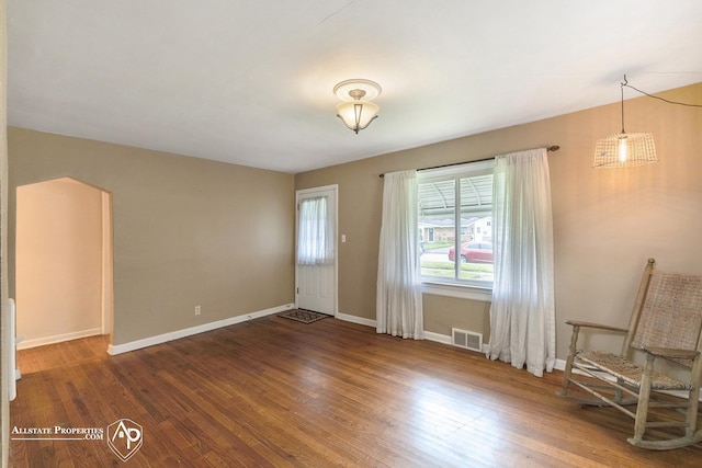 spare room featuring wood finished floors and baseboards