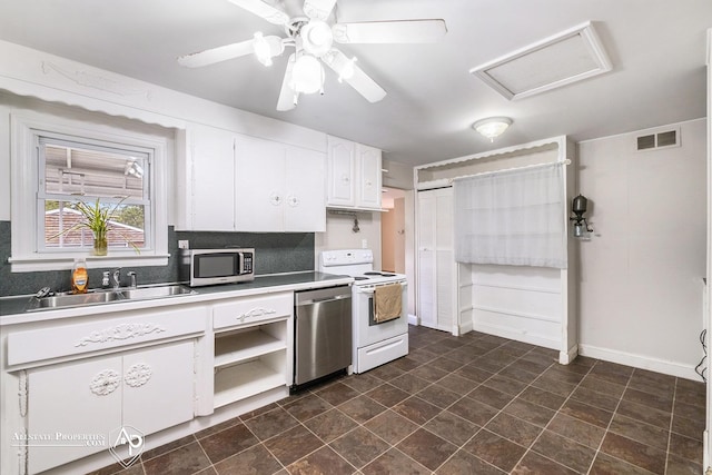 kitchen featuring appliances with stainless steel finishes, a sink, white cabinetry, tasteful backsplash, and light countertops