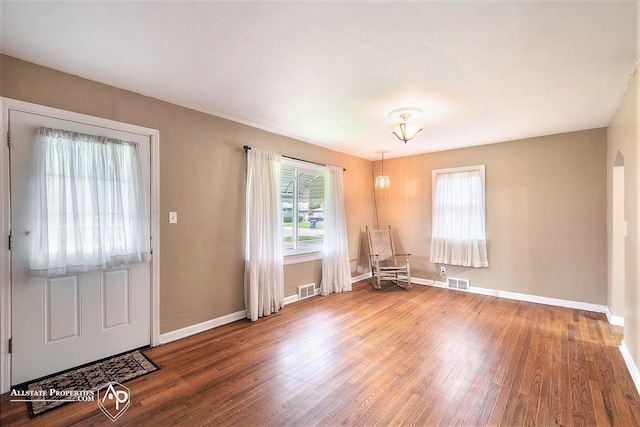 foyer featuring healthy amount of natural light, wood finished floors, and baseboards