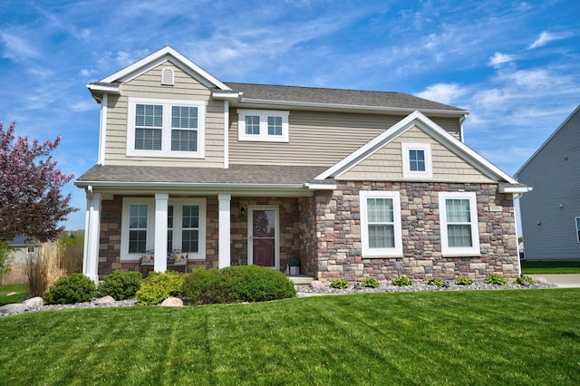 7051 Wildflower, Grand Blanc, MI 48439 - view of front facade with a front yard, stone siding, a shingled roof, and a porch