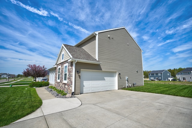 7051 Wildflower, Grand Blanc, MI 48439 - view of home's exterior featuring stone siding, a lawn, concrete driveway, and a shingled roof