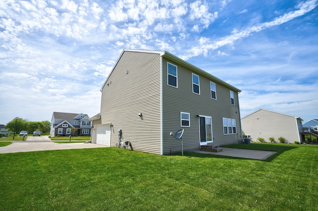 7051 Wildflower, Grand Blanc, MI 48439 - back of property with driveway, a lawn, an attached garage, and central air condition unit