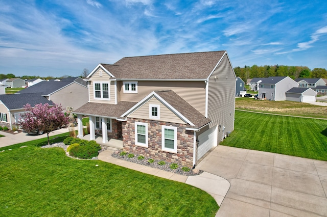 7051 Wildflower, Grand Blanc, MI 48439 - view of front of home with driveway, a porch, a residential view, stone siding, and a front yard