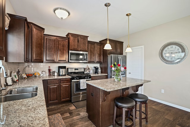 7051 Wildflower, Grand Blanc, MI 48439 - kitchen with stainless steel appliances, dark wood-type flooring, dark brown cabinets, and a center island
