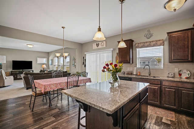 7051 Wildflower, Grand Blanc, MI 48439 - kitchen featuring a sink, dark brown cabinets, dark wood-style floors, and a kitchen bar