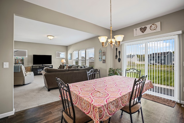 7051 Wildflower, Grand Blanc, MI 48439 - dining space featuring a chandelier, dark wood finished floors, and baseboards