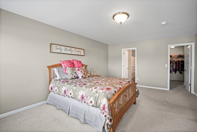 7051 Wildflower, Grand Blanc, MI 48439 - carpeted bedroom with baseboards, a spacious closet, a closet, and ensuite bathroom