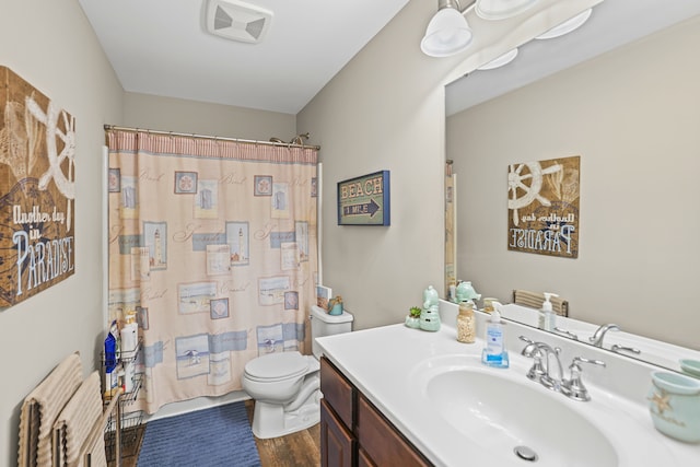 7051 Wildflower, Grand Blanc, MI 48439 - bathroom featuring wood finished floors, toilet, vanity, radiator heating unit, and shower / tub combo