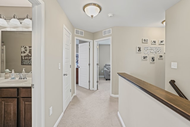 7051 Wildflower, Grand Blanc, MI 48439 - hall with a sink, an upstairs landing, light colored carpet, and baseboards