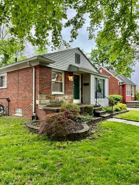 11427 Mercedes, Redford, MI 48239 - view of front of house featuring a front yard, a porch, and brick siding